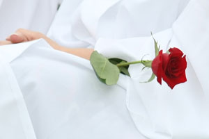 In the spirit of tradition, each female graduate holds a rose.