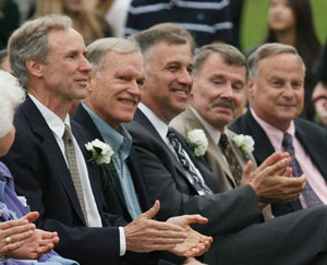 John Lee, Pete Jackson, Dennis DeGara, Tom Hill, and George Bernauer applaud the graduates.