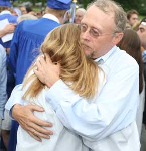Ray Dunn gives his daughter, new graduate Bo, a hug after the ceremony.