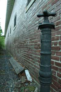 A water pump stands next to the former horse stable which housed up to 40 horses during the days of Camp Devens.