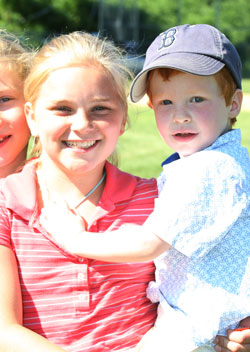 Olivia Phillips gives cousin Aidan Taylor a ride on her hip.