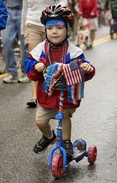 Three-year-old William Gothorpe decorated his scooter instead of a bike for the parade. (Photo by Ellen Harasimowicz)