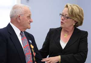 Roland Martineau listens as Congesswoman Niki Tsongas talks about her father’s service in World War II. Representative Tsongas and her staff were instrumental in obtaining Mr. Martineau’s long-awaited medals. After the war, Martineau was in a hurry to return home and didn’t want to wait to receive the medals then.