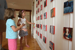 Julia (left) and Phoebe Clark look over the artwork of Gail Martin on the second floor of the General Store. (Photo by Lisa Aciukewicz)