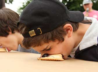 Ryan Holmes on his way to winning the pie-eating contest in the 15- to 18-year-old boys division. (Photo by Lisa Aciukewicz)