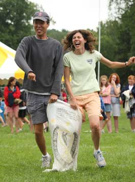 Rainer Park and Kristan Smith-Park come in dead last in the sack race, but don’t let it stop them from having a great time. (Photo by Lisa Aciukewicz)