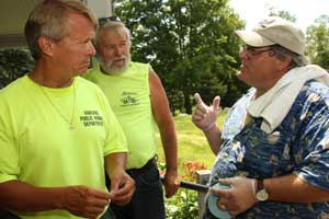 Steve Johnson and Bob Melvin of the Department of Public Works talk to Town Administrator Tim Bragan at a barbeque held at the Hildreth House in July for town employees.