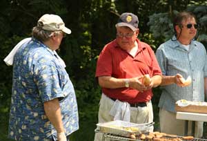 Town Administrator Tim Bragan talks with selectmen Peter Warren (center) and Ron Ricci as they prepare lunch