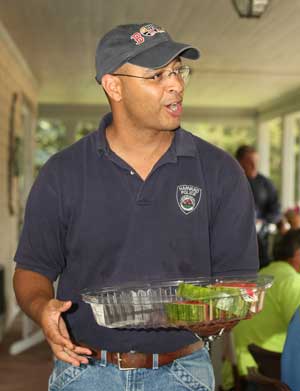 Chief Ed Denmark takes a break from police work to hand out watermelon.
