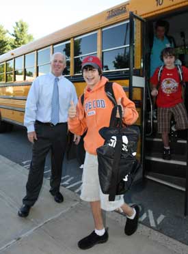 Principal Jim O’Shea greets Erik Johnson as he steps off the bus at Bromfield on the first day of school. (Photo by Lisa Aciukewicz) Principal Jim O’Shea greets Erik Johnson as he steps off the bus at Bromfield on the first day of school. (Photo by Lisa Aciukewicz)