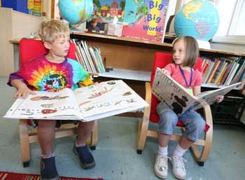 Jacob Morine and Tori Ferguson enjoy the book corner in Mrs. Ambrosino’s kindergarten classroom on their first day of school. 