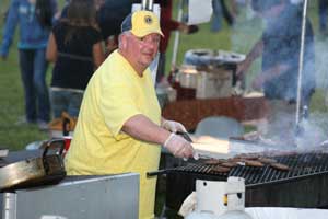 Gary Clements cooks burgers for the crowd at the Lions Club Fall Festival