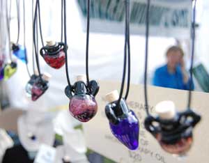 Aromatherapy bottles sold by Crystal Clark of Dances with Fire hang from a stand at the craft fair. (Photo by Laura Zupancic)