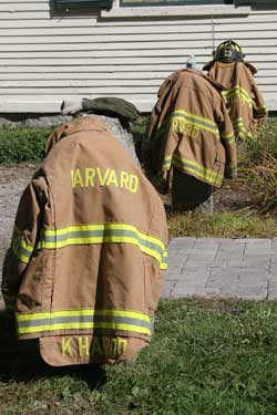 Firefighters' coats rest on granite pillars in front of the Historical Society after the fire was put out.