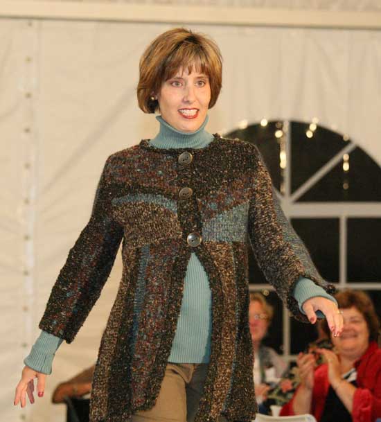 Marcie Donahue strides the catwalk in a striped boucle cardigan by Curio.