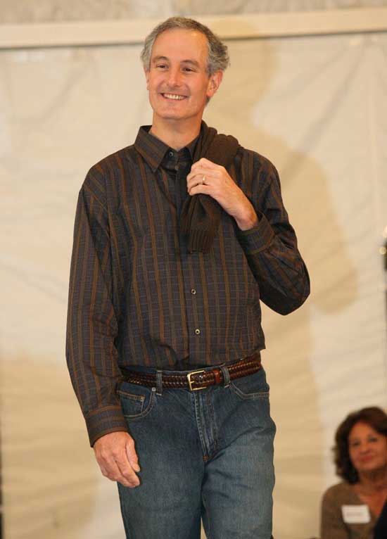 Nick Browse is casual in a sport shirt and sweater by Cotton Reel.