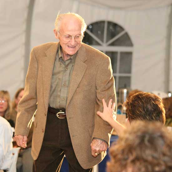 Paul VonLoesecke pauses so the audience members can feel the fabric of his Gould’s brand taupe camel hair jacket.