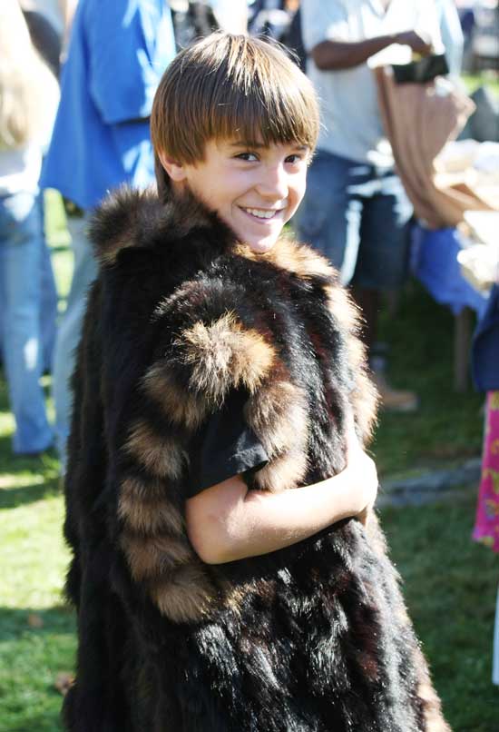 Ryan Ashe models a fur coat. 
