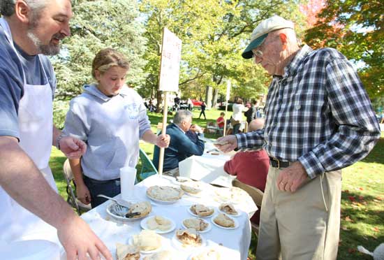 Dave and Alyson Marteney serve pie to Arthur Lazarus.