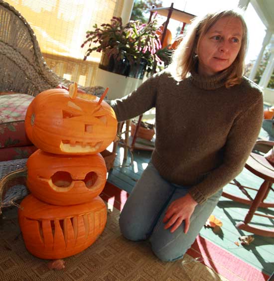 Ann Tenero poses with a few of her pumpkins from the Pumpkin Plant.