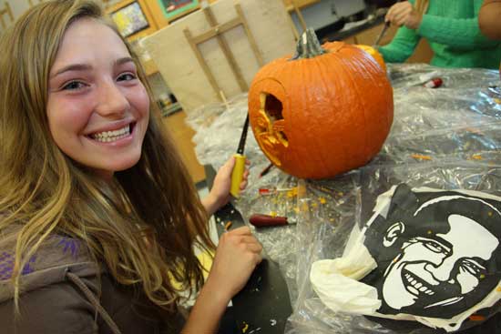 Margaux Holley carves Barack Obama’s likeness on her pumpkin.