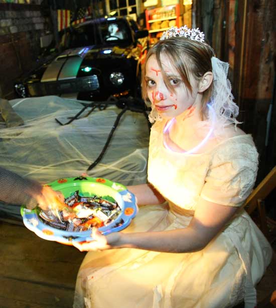 A scary Ciara Connolly hands out candy in her family’s barn on Fairbanks Street
