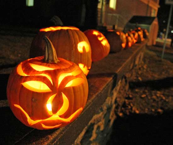 Glowing jack-o-lanterns lit the wall next to the General Store.