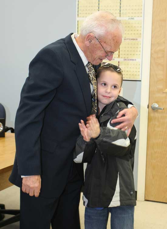 Amedee Bourgeois hugs his great-grandson Dylan Goodspeed, who claps for his great-grandfather during a ceremony in which Bourgeois received six medals for his service in the Korean conflict. Bourgeois maintained fighter planes from a base in Japan during the conflict.
