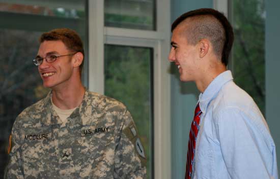Veteran John McClure (left) and junior Ben Landry talk after a Veterans Day ceremony at Bromfield last Friday. (Photo by Sue Fitterman)