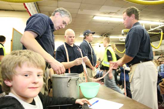 Jimmy Nigzus eyes the camera as dad Charlie Nigzus, Wally Shaw, and Dave Hazel sort out tickets.