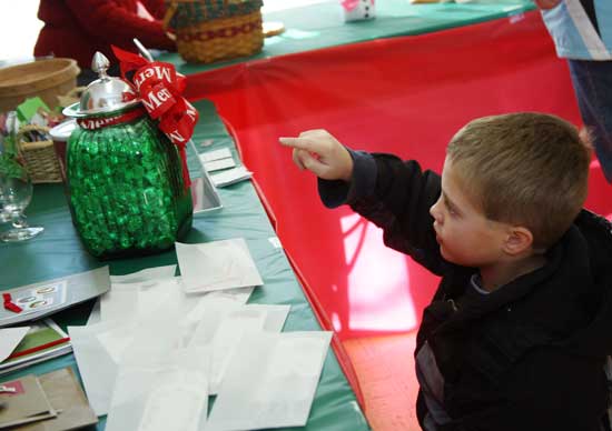 Ryan Robinson tries to figure out how many Hershey’s kisses are in a jar at the Congregational Church’s annual holiday fair.