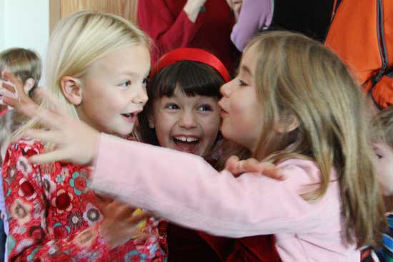 Hayley Minar, Emily Brown, and Madison Drummey share their enthusiasm as they wait to meet with Santa.