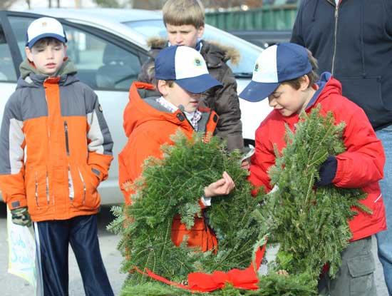 Cub Scouts (left to right) William Hooper, Aaron Hawksley, Jason Lancellotti, and Austin Franklin sell wreaths at the transfer station last Saturday.