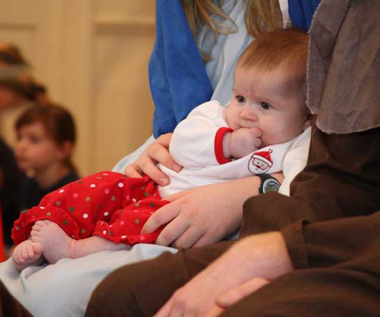 Brianna Murphy takes in the scene as Baby Jesus.