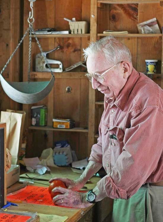 Jeff Harris purchases tomatoes at Willard’s Farmstand in August.
