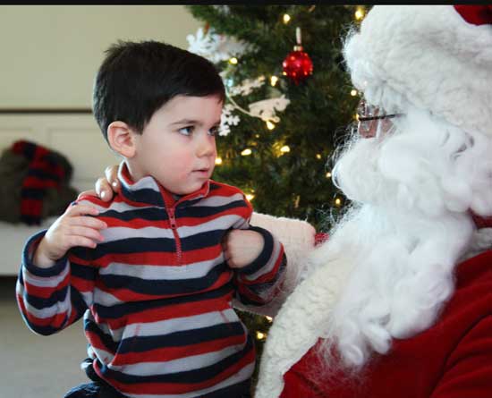 Conor Knoettner has a serious talk with Santa at the Congregational Church.