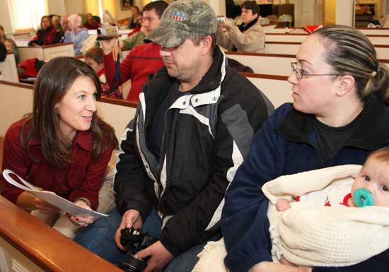 Pageant co-chair Suzanne Dutkewych discusses the script with Sean and Kim Murphy before baby Brianna steps into her role as Baby Jesus.