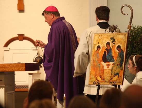 Bishop Robert McManus returns to the altar after blessing the icon that will represent Holy Trinity parish, the merger of St. Theresa parish of Harvard and St.Francis Xaviar of Bolton.