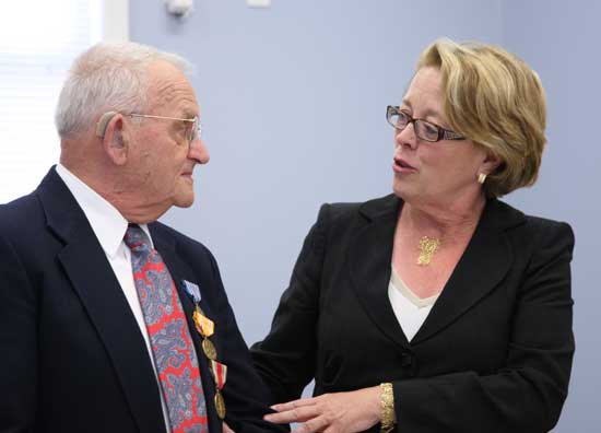 Former Seabee Roland Martineau receives a medal from Congesswoman Niki Tsongas. Representative Tsongas was instrumental in obtaining Mr. Martineau’s long-awaited World War II medals.