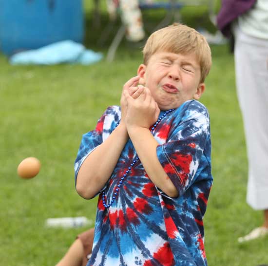 Chris Pickreign almost catches his egg in the Fourth of July activities in front of Old Bromfield.