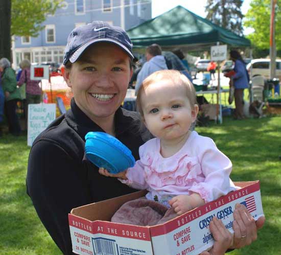While her mom Amanda Zaikis Gleason decides what to buy at the Garden Club plant sale in May, baby Rayna enjoys the ride. (Photo by Sue Fitterman)