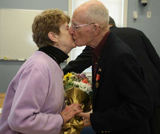 Doris and PJ Johnston share a kiss on Veterans Day as PJ is recognized for his service as commander of American Legion Post 119 of Harvard.