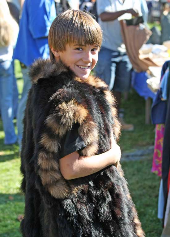 Ryan Ashe models a fur coat he found at the Columbus Day Weekend Flea Market.