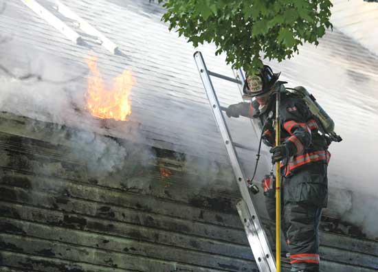 Firefighters work to save the Harvard Historical Society during a fire in September. As a result of their efforts, the building was saved.