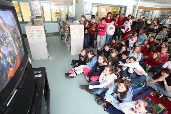 Fourth- and fifth-graders watch the inaugural address in the library at the elementary school.
