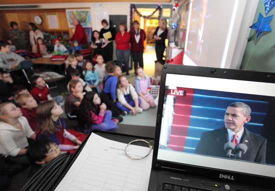 Third-graders watch Barack Obama’s inaugural address on CNN streamed through a computer to a smart board in their classroom.