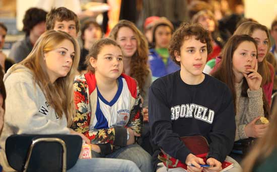 Ninth-graders Kaya Phillips. Katie Lovelock, and Jacob Klein listen in the Bromfield cafeteria.