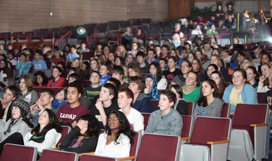 Seventh- and eighth-graders watch the inaugural address in the Cronin Auditorium at Bromfield. 