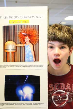 Sam Fishbein poses next to his science project on the Van de Graaff generator.