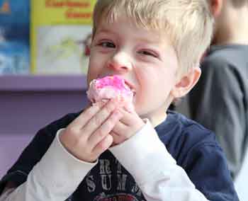 A Barn School student enjoys his Valentine cupcake.